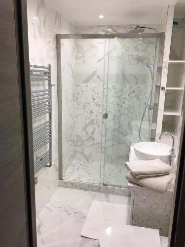 une salle de bain blanche avec une douche et un lavabo dans l'établissement Calme, lumineux, luxueux, refait á neuf, à Sartrouville