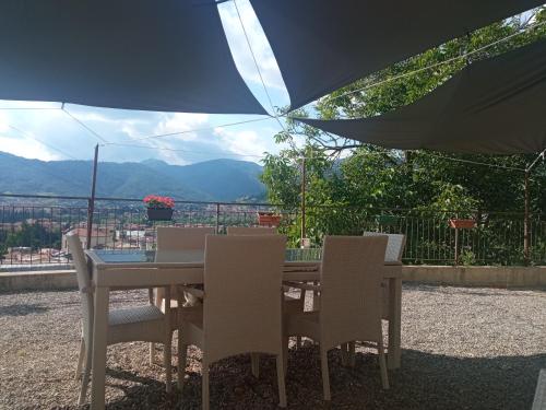 a table and chairs with a view of the mountains at Bergamo bnb in Villa di Serio