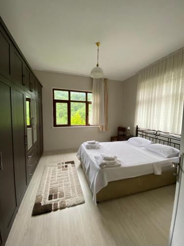 a bedroom with a large bed and a window at Yomra İkisu Garden House in Yomra