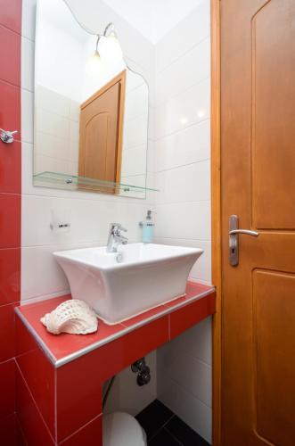 a bathroom with a sink and a mirror at Orama Apartments in Agia Anna Naxos