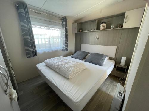 Cette petite chambre comprend un grand lit blanc. dans l'établissement le coup de coeur, à Berck-sur-Mer