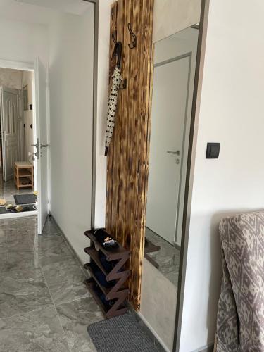 a large mirror in a room with some shoes in it at APARTMENTS IVANOViC CENTER CITY in Bajina Bašta