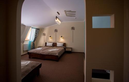 a hotel room with two beds and a window at Mіnі Gotel Pozitiv in Horodets'ke