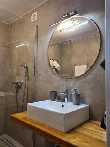 a bathroom with a white sink and a mirror at ZARA APARTMENT in Banjole