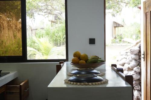 a bowl of fruit on a table in a kitchen at CosyBe Villas in Praia do Tofo
