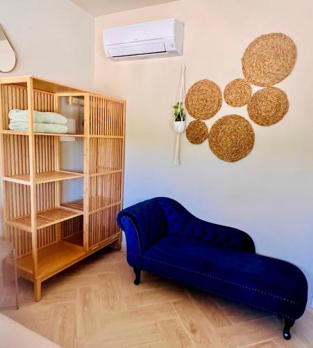 a blue couch in a room with a book shelf at Casa de Los Lirios in Muro de Alcoy