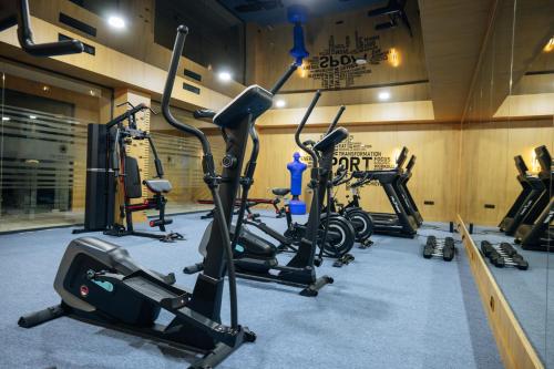a gym with several exercise bikes in a room at Kohinur Plaza in Samarkand