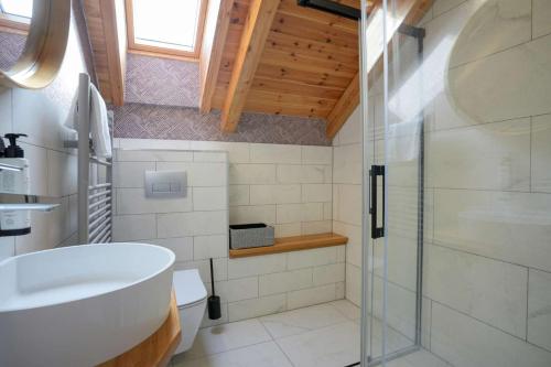 a bathroom with a sink and a glass shower at ChaChaCha House Vendégház in Egerszalók