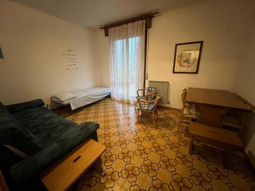 a living room with a couch and a desk at Casa Rossa al Lago - Apt Terrazza in Spinone Al Lago