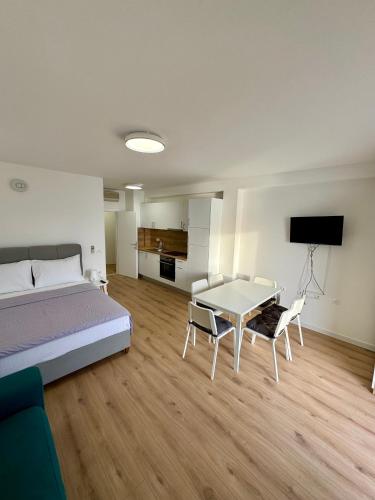 a bedroom with a bed and a table and chairs at Villa Rozika in Baška Voda