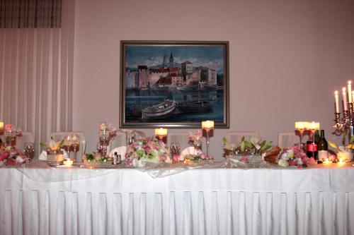 a table with candles and flowers on top of it at Hotel Sveti Kriz in Trogir