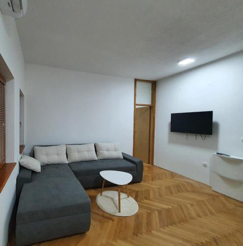 a living room with a couch and a tv at Dream On in Žepče