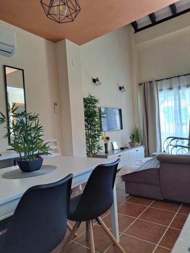a living room with a table and chairs and a couch at Casa rural La Abuela in El Ronquillo