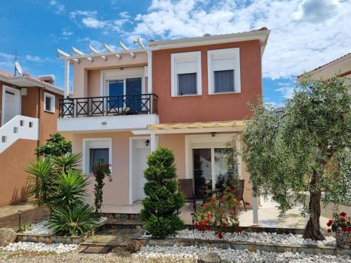 a house in the suburbs with trees and bushes at Oikies in Prinos
