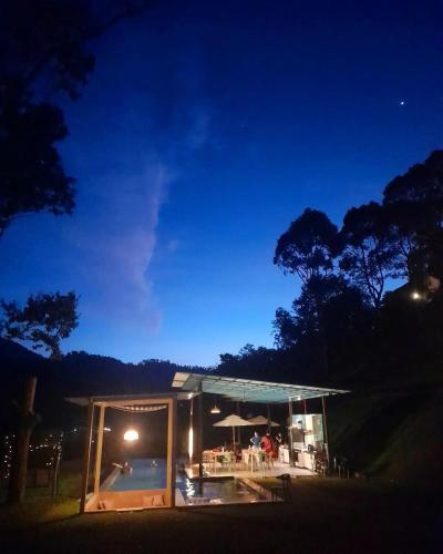a house with a glass roof at night at The Hill in Kampong Sum Sum