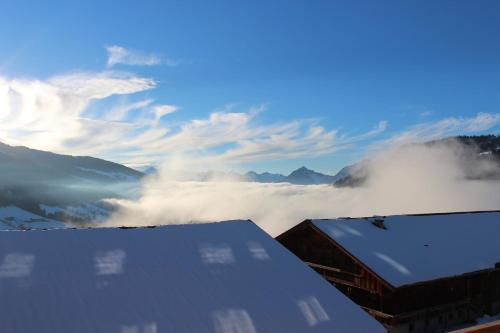 a view of a snow covered mountain with clouds at Alpengasthof Rossmoos in Alpbach