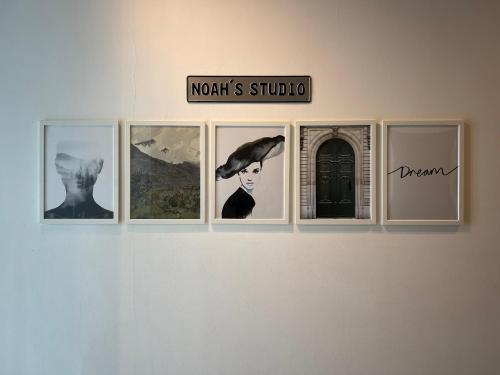 a group of pictures hanging on a wall at Noah's Studio in Shah Alam