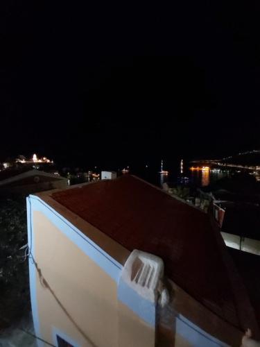 a rooftop of a building at night with a dark sky at 89 Steps Symi in Symi