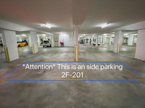 an empty parking lot with a sign in the middle at Minimalist Muji Inspired at Mount Austin, JB #04 in Johor Bahru