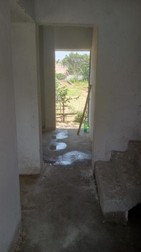 an empty room with an open door in a house at RRc 11 in Katihār