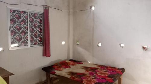 a room with a table with flowers on it at RRc 11 in Katihār