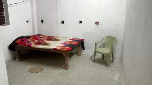 a small table and a chair in a room at RRc 11 in Katihār