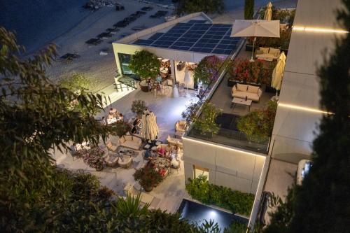 an overhead view of a building with a patio at night at Hotel Medistone in Omiš