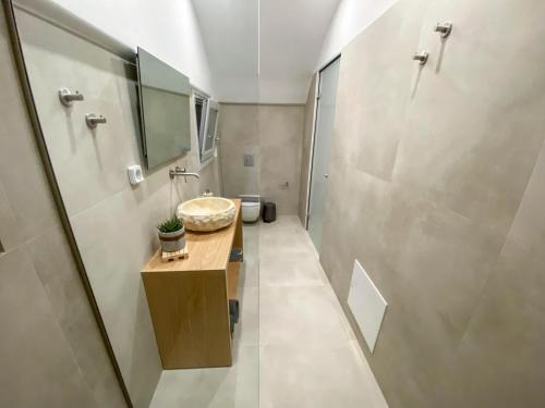a bathroom with a sink and a shower at Nohēme Luxury Suites in Vourvoulos