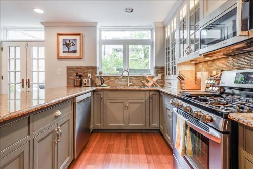 a kitchen with a sink and a stove at Artist Residence 3 Bedroom Brownstone in Hoboken
