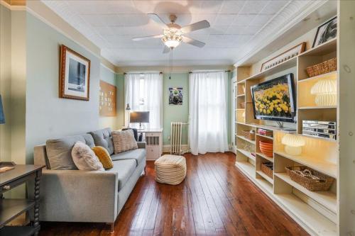 a living room with a couch and a tv at Artist Residence 3 Bedroom Brownstone in Hoboken