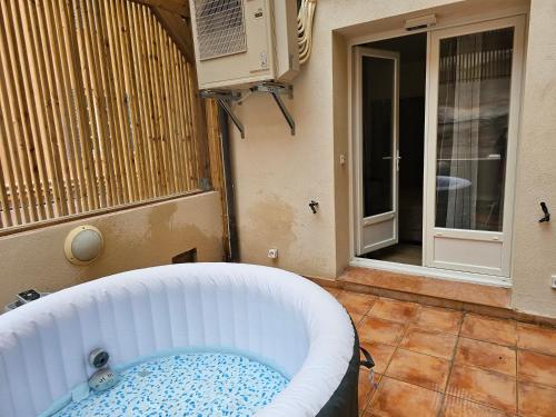 a bath tub sitting in the corner of a room at L'Escale in Bonifacio