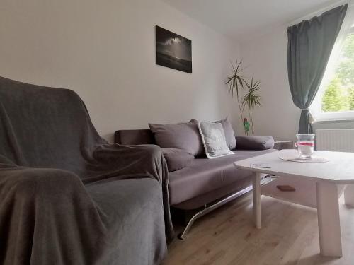 a living room with a couch and a table at Walls 1 in Wallsbüll