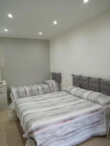 a group of four beds in a room at Villa Sandro in Agropoli