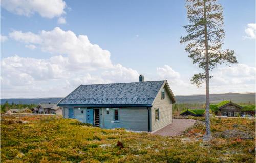 a small blue and white house on a hill at 4 Bedroom Lovely Home In Østby in Østby
