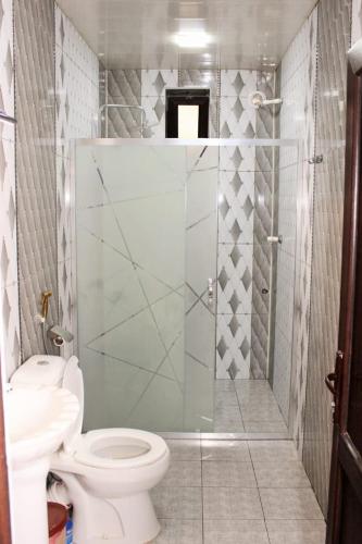 a bathroom with a toilet and a glass shower at Daire in Ganja