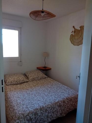 une chambre avec un lit et une fenêtre dans l'établissement face a la mer, à La Londe-les-Maures