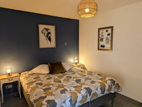 a bedroom with a bed and two night stands at Studio Les chambres de la source - Milouin in Sancourt