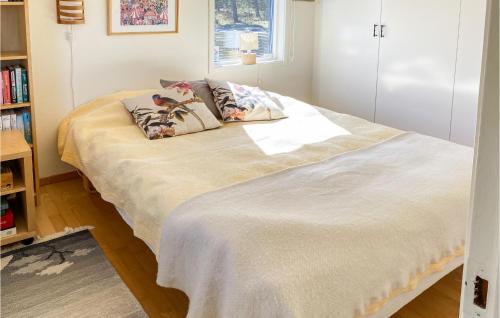 a bedroom with a bed with two pillows on it at Stunning Home In Skummeslövsstrand in Skummeslövsstrand