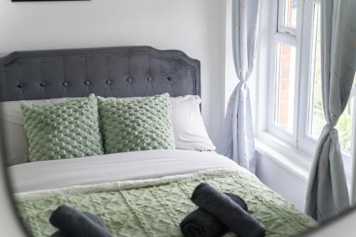 a bed with two black teddy bears on it at Open Mind Property - HotTub, 8 Beds & 2 Car Spaces in Portsmouth