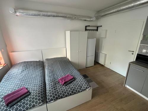 a room with a bed with two purple pillows on it at Top Apartments in Kamen - Cozystays in Kamen