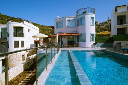 a villa with a swimming pool and a house at Villa Manolya in Kalkan