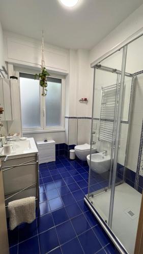 a bathroom with a shower and a sink and a toilet at Casa La Dolce Pesca in Genoa