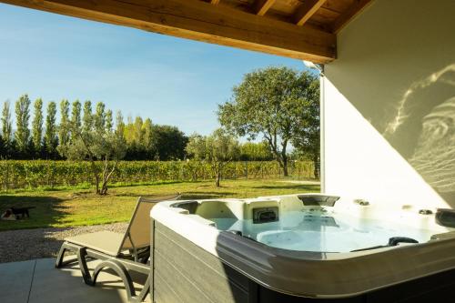 a hot tub on a patio with a view of a yard at Domaine Saint Thomas in Argelès-sur-Mer