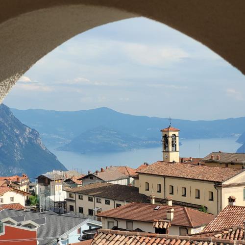 a view of a city with a clock tower at Castello Mountain Lake Iseo Hospitaty in Bossico