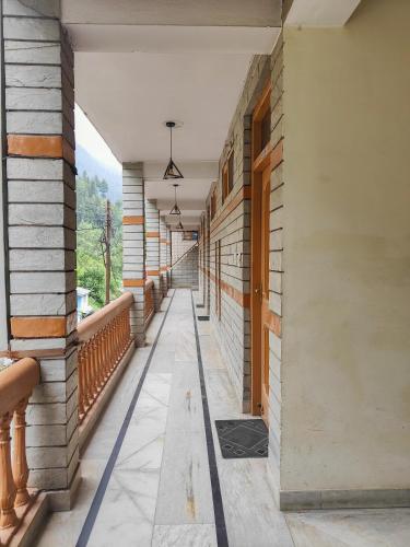 an empty corridor of a building with a balcony at Hotel Arohi in Vashisht
