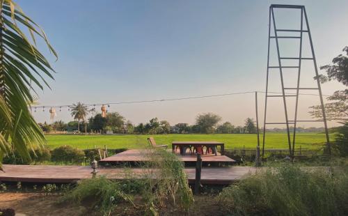 a group of people sitting on a wooden deck at BREATHE - Rice Valley in Ban Pa Lan