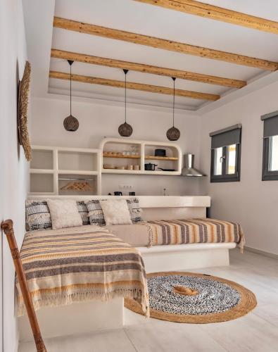 a living room with two beds and a couch at Alonia Suites in Naousa