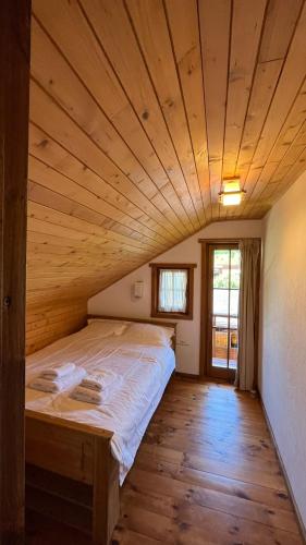 a large bed in a room with a wooden ceiling at Casa Adrian in Cluj-Napoca