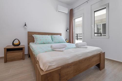 een slaapkamer met een groot bed met twee kussens erop bij Andreas Rodos Apartment in Rhodos-stad