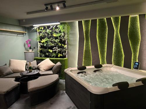 a jacuzzi tub in a living room with plants at LEO Apartment FREE PARKING - President Palace in Bratislava